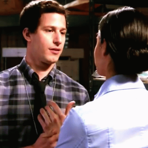 Man In Plaid Shirt And Tie Talking To Woman In Blue Shirt And Tie GIF