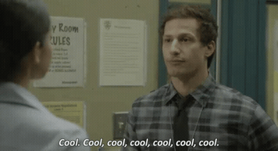 Man In Plaid Shirt And Tie Talking To Woman In Hallway GIF