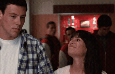 Man In Plaid Shirt And Woman In White Shirt Standing Together GIF