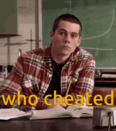 Man In Plaid Shirt At Desk With Chalkboard Saying Who Cheated GIF
