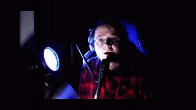 Man in Plaid Shirt at Microphone Par Respect Freno