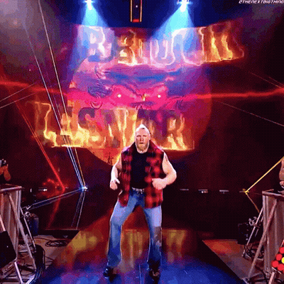 Man In Plaid Shirt Dancing In Front Of Brock Lesnar Screen GIF