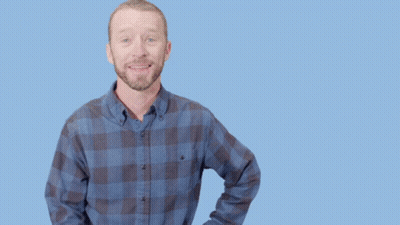 Man In Plaid Shirt Doing Call Me Gesture GIF