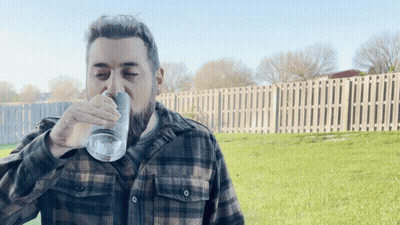 Man In Plaid Shirt Drinking From Glass GIF