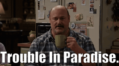 Man in Plaid Shirt Drinking From Green Mug Trouble in Paradise