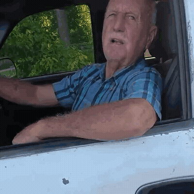 Man In Plaid Shirt Driving White Truck GIF