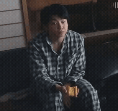 Man In Plaid Shirt Eating Snack GIF