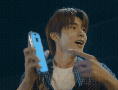 Man In Plaid Shirt Holding Blue Phone GIF