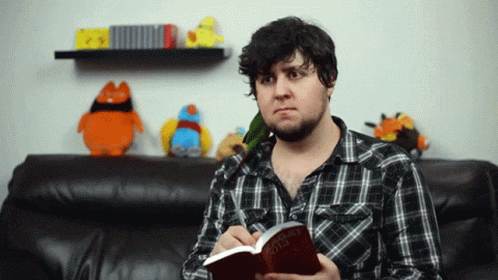 Man In Plaid Shirt Holding Book The Hobbit GIF