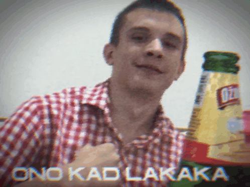 Man In Plaid Shirt Holding Bottle Of Ritz GIF