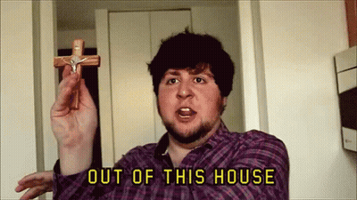 Man In Plaid Shirt Holding Cross Out Of This House GIF