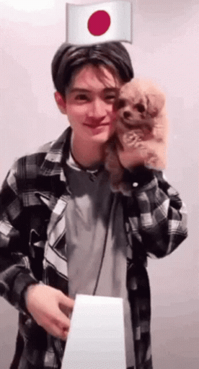 Man In Plaid Shirt Holding Dog With Japanese Flag GIF