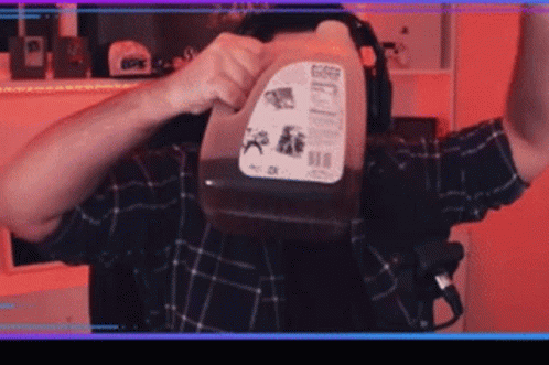 Man In Plaid Shirt Holding Gallon Of Milk GIF