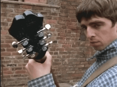Man In Plaid Shirt Holding Guitar GIF
