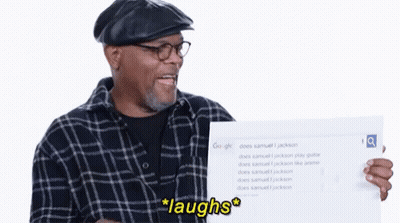 Man In Plaid Shirt Holding Laughs Sign GIF