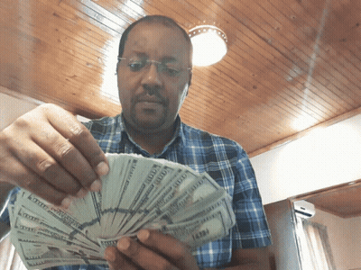 Man In Plaid Shirt Holding Money GIF