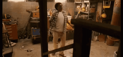 Man In Plaid Shirt Holding Saw GIF