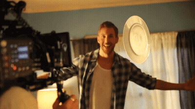 Man In Plaid Shirt Holding White Plate GIF