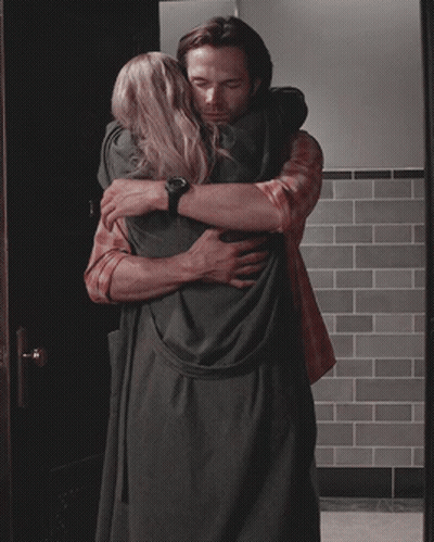 Man In Plaid Shirt Hugging Woman In Black Dress GIF
