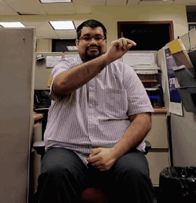 Man In Plaid Shirt In Cubicle Saying A GIF