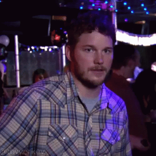Man In Plaid Shirt In Dark Room With Purple Lights GIF