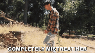 Man In Plaid Shirt In Field Saying Completely Mistreat Her GIF