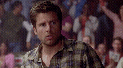 Man In Plaid Shirt In Front Of Crowd GIF