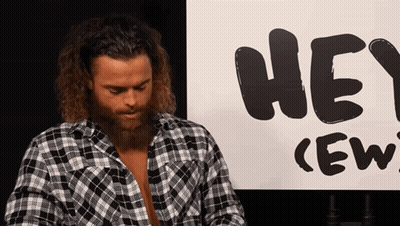 Man In Plaid Shirt In Front Of Hey Crew Sign GIF