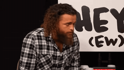 Man In Plaid Shirt In Front Of Hey Ew Sign GIF