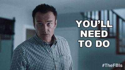 Man In Plaid Shirt In Front Of Sign Saying You'll Need To Do GIF
