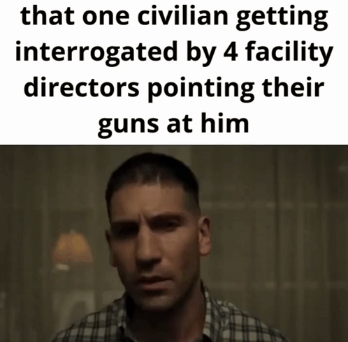 Man In Plaid Shirt Interrogated By Facility Directors GIF