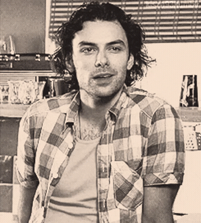 Man In Plaid Shirt Looking At Camera GIF
