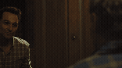 Man In Plaid Shirt Looking At Reflection GIF
