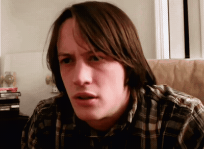 Man in Plaid Shirt Making a Face