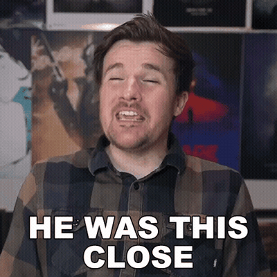 Man In Plaid Shirt Making Face He Was This Close GIF