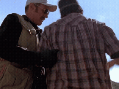 Man In Plaid Shirt Next To Man In Baseball Cap GIF
