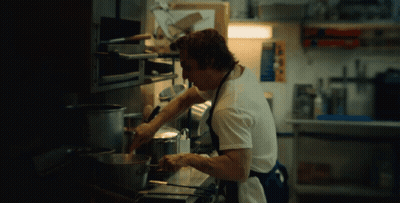 Man In Plaid Shirt Next To Man In Black GIF