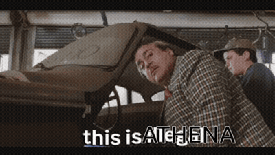 Man In Plaid Shirt Next To Man In Hat GIF