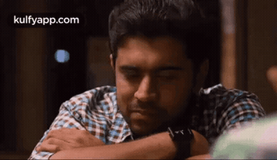 Man In Plaid Shirt Resting Head On Arm Eyes Closed GIF