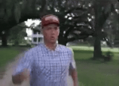 Man In Plaid Shirt Running In Park GIF