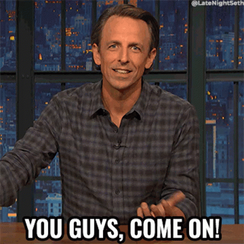 Man In Plaid Shirt Says You Guys Come On In Front Of City Skyline GIF
