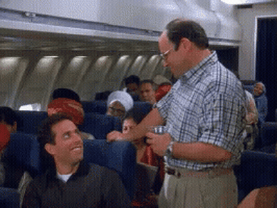 Man In Plaid Shirt Serving Drink On Plane GIF