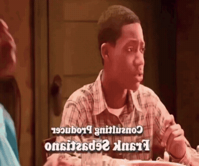 Man In Plaid Shirt Sitting At Table With Food GIF
