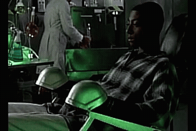 Man In Plaid Shirt Sitting In Green Lab Chair GIF