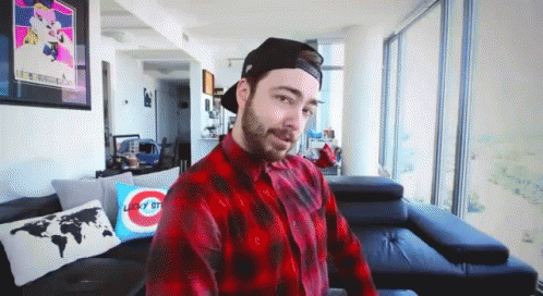 Man In Plaid Shirt Sitting On Couch GIF
