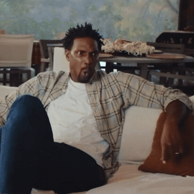 Man In Plaid Shirt Sitting On Couch GIF