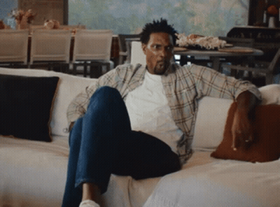 Man In Plaid Shirt Sitting On Couch GIF