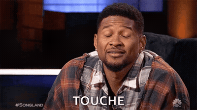 Man In Plaid Shirt Sitting With Eyes Closed Saying Touche GIF