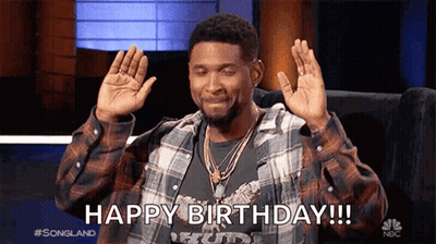Man In Plaid Shirt Sitting With Hands Up Says Happy Birthday GIF