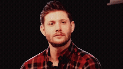 Man In Plaid Shirt Smiling Holding Microphone GIF